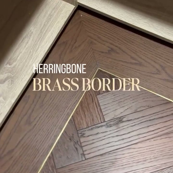 Mountain Deep Smoked Oak herringbone with a plank border and brass inlay, fitted by Kidd Flooring
