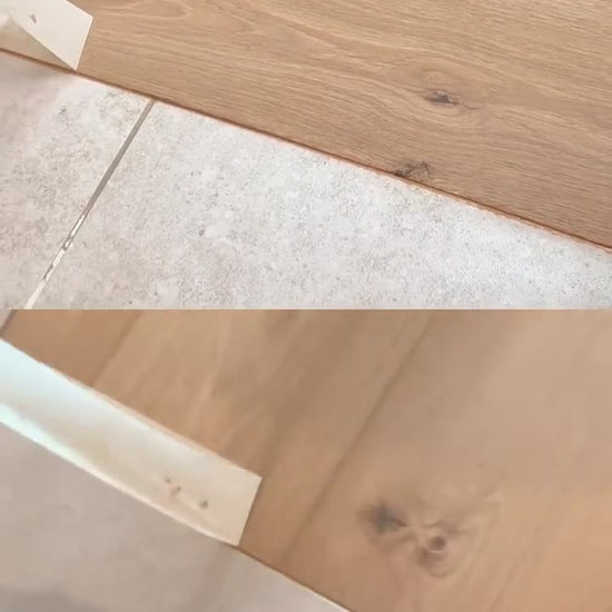Mountain Mist Oak engineered plank fitted by Kidd Flooring with a colour-matched joint to the tiles