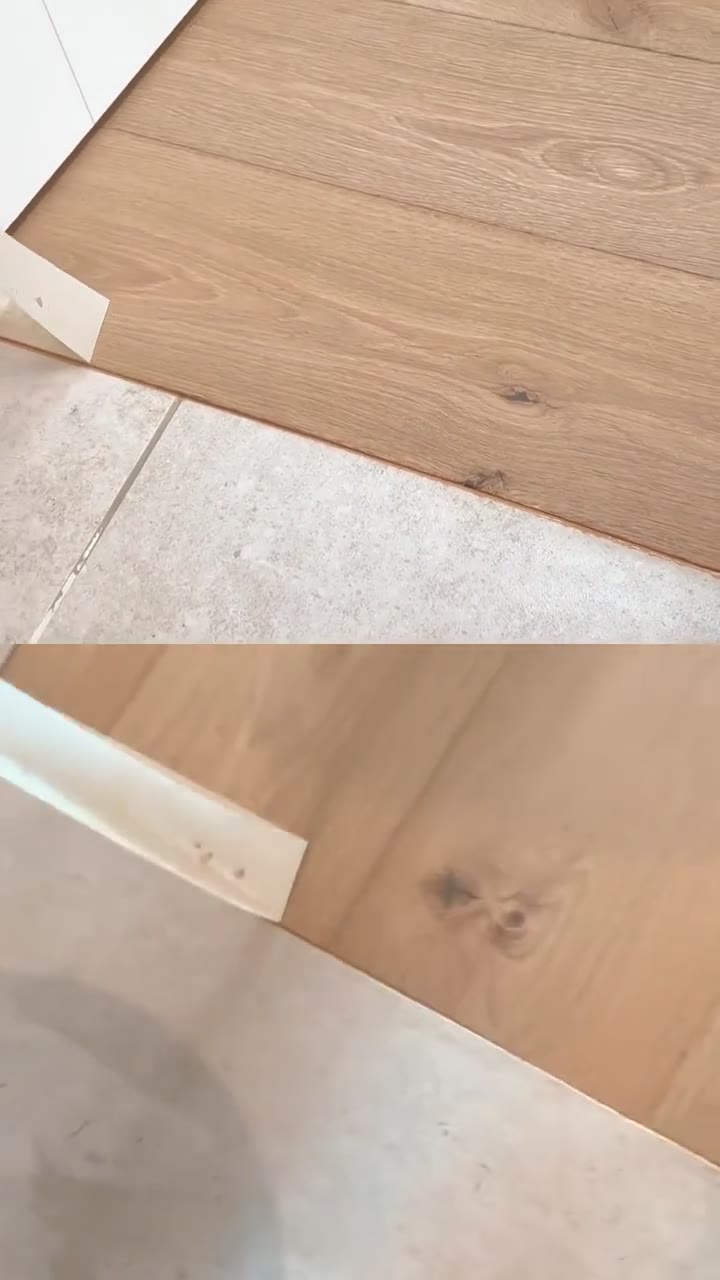 Mountain Mist Oak engineered plank fitted by Kidd Flooring with a colour-matched joint to the tiles