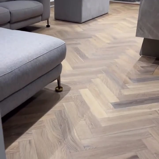 Mountain Ridge Oak herringbone with a plank border and brass inlay, fitted by Kidd Flooring