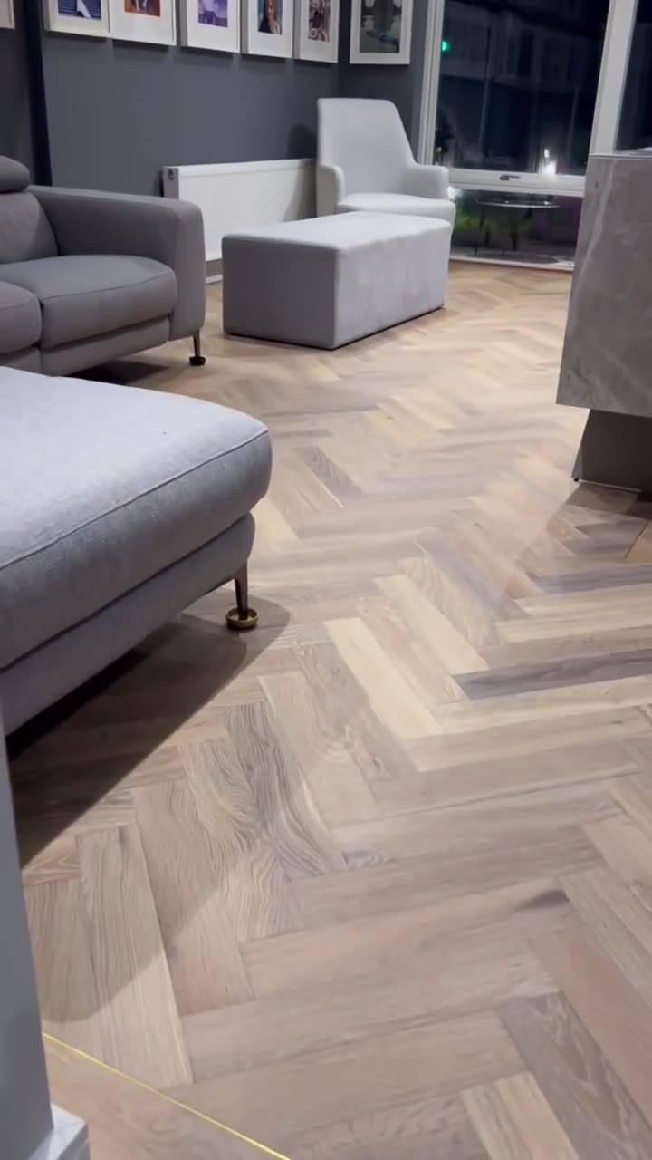 Mountain Ridge Oak herringbone with a plank border and brass inlay, fitted by Kidd Flooring
