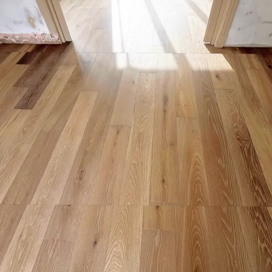Mountain Ridge Oak plank in a kitchen and living room with matching herringbone in the hall, fitted by Kidd Flooring